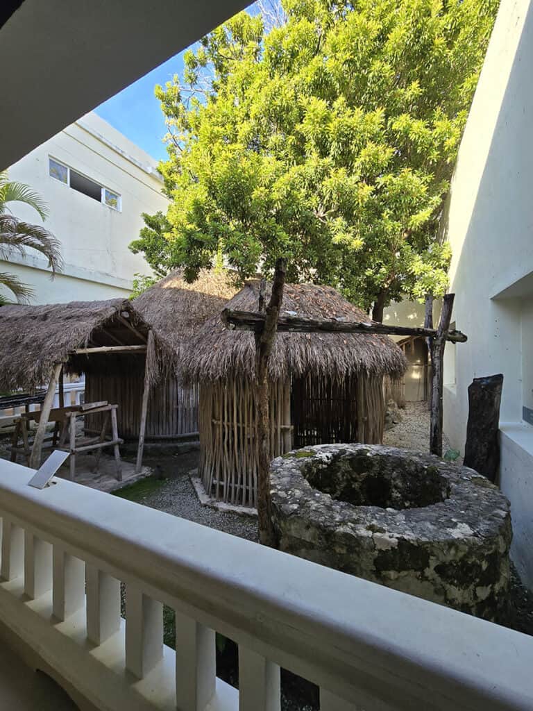 An outdoor exhibit of a traditional Mayan village at Cozumel Museum.